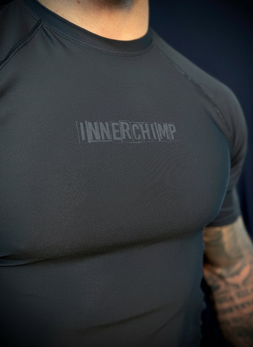 Person wearing a dark gray athletic shirt with 'INNERCHIMP' logo on a dark background